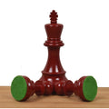 Standing burgundy Prime Staunton king alongside two fallen pieces displaying their green felt bases for board protection.