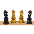 Detailed profile view of four carved ebony and antiqued boxwood Calvert style chess knights.