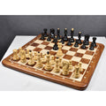 Full Russian Zagreb ebonized and boxwood chess pieces set up on a wooden board.