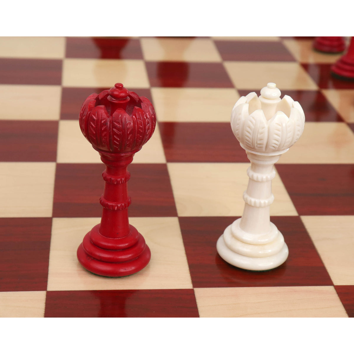Crimson and white Turkish Tower pre-Staunton chess pieces side by side.