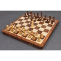 Large 20 inch wooden travel chess set with Staunton pieces arranged for play on a rosewood and maple surface.