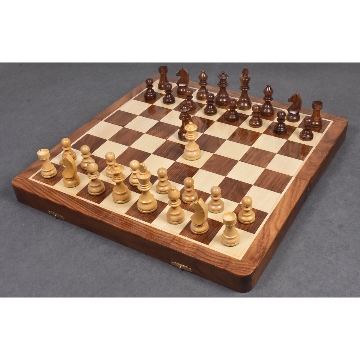 Large 20 inch wooden travel chess set with Staunton pieces arranged for play on a rosewood and maple surface.