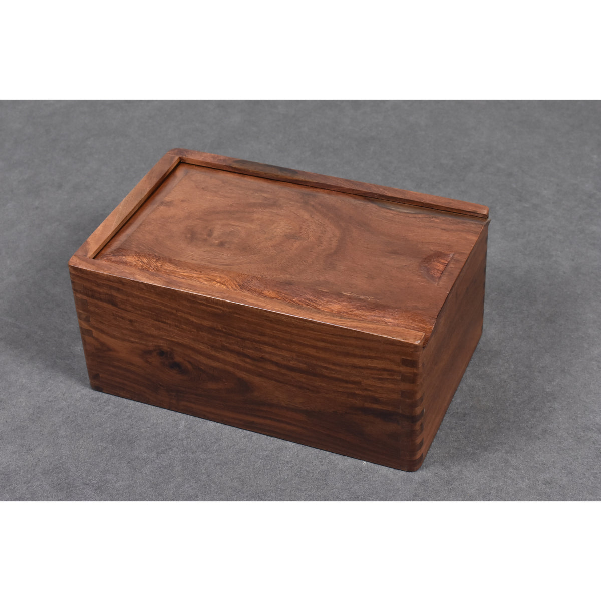 Closed rectangular golden rosewood chess pieces storage box displaying natural grain and finger joints.