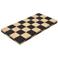 Partially rolled ebony and maple wood travel chess board showing flexibility.