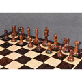 Dark rosewood 3.9" Craftsman Staunton chess pieces arranged in starting rows on a glossy wooden chessboard.