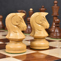Profile close-up of two hand-carved Boxwood Knights from the 1970s Dubrovnik chess set on a board.