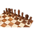 Dark golden rosewood minimalist Berliner chess pieces lined up on a wooden chessboard.