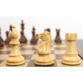 Light boxwood Staunton bishop, knight, and rook displayed closely on a wooden chessboard.
