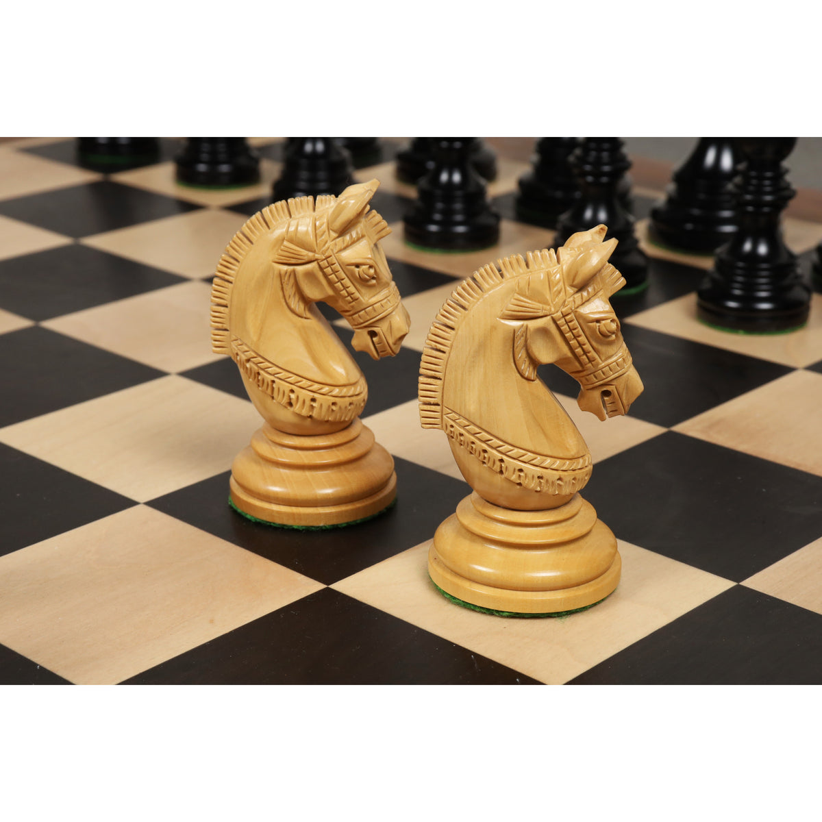 Hand-carved Stallion Staunton knight pieces on an ebony and maple board.