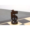 Profile view of a finely crafted dark Anjan rosewood knight from the Pinney Staunton chess set.