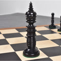 Close-up of a black Minaret series hand-carved camel bone king chess piece on a board.