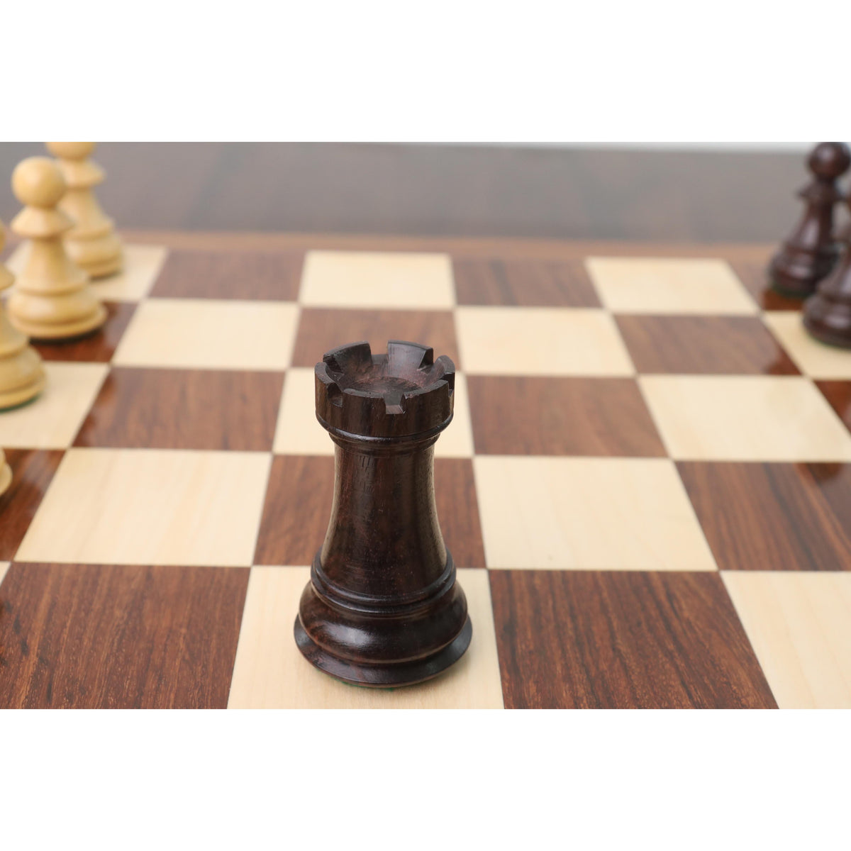 Fine-grained dark rosewood rook piece showing distinct Zagreb style castle battlements.