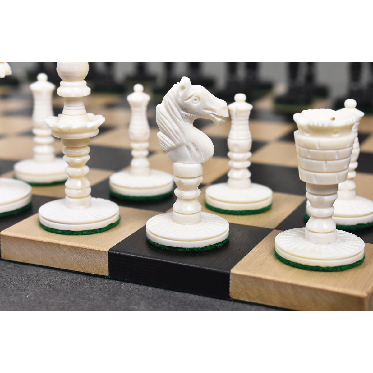 Close-up of the white Knight and Rook from the English pre-Staunton camel bone set.
