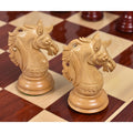 Two hand-carved light boxwood Staunton knight chess pieces on a board.