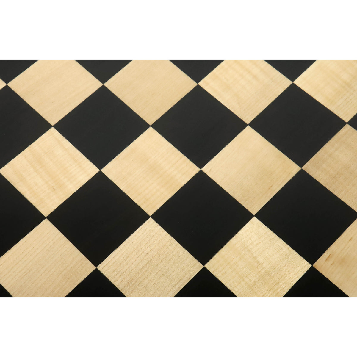 Detail shot of the natural wood grain on the 55mm ebony and maple squares of a handcrafted chess board.
