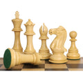 Natural boxwood luxury Staunton chess pieces lined up with one rook overturned displaying its green felted bottom.