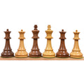 Golden rosewood and boxwood French Grandmaster king and queen chess pieces on display.