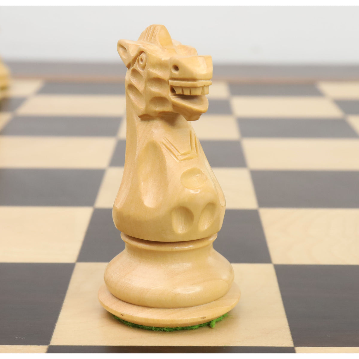 Detailed profile of the white boxwood knight from the 3.7" British Staunton weighted chess set.