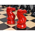 Detailed red Staunton knight chess pieces on a wooden board.