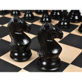 Close-up of two hand-carved black ebonised boxwood knight pieces from the Majestic Series.