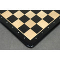 High-angle shot showing the rounded corners and smooth finish of an ebony wood chess board with coordinate notation.