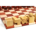 Boxwood Bauhaus chess pieces arranged on the board from a corner angle.