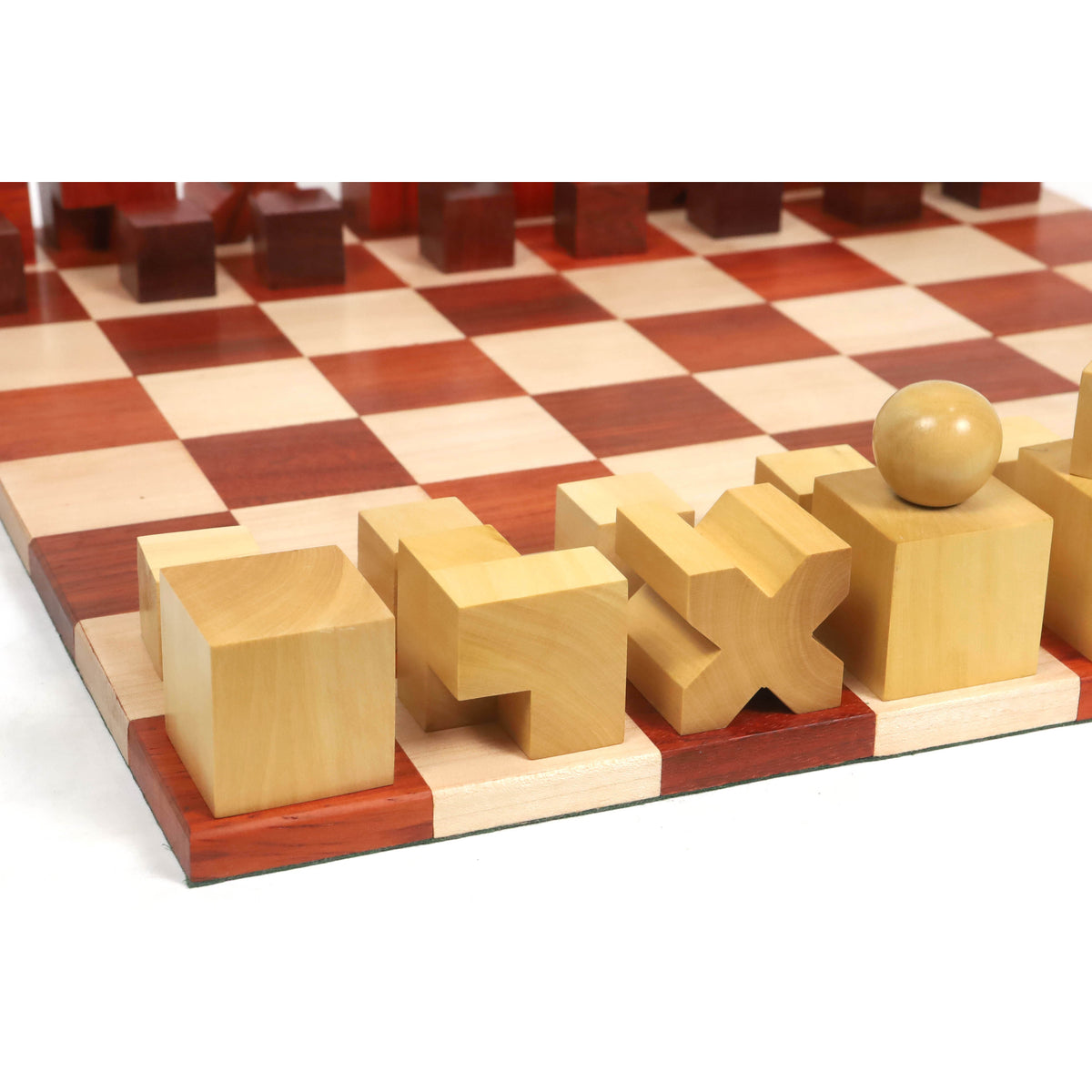 Boxwood Bauhaus chess pieces arranged on the board from a corner angle.