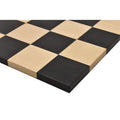 Macro close-up of the squares on the solid wood roll up travel chess board.