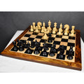 Complete 4.4 inch Dragon Luxury Staunton chess set with ebony and boxwood pieces arranged fully on a chessboard.