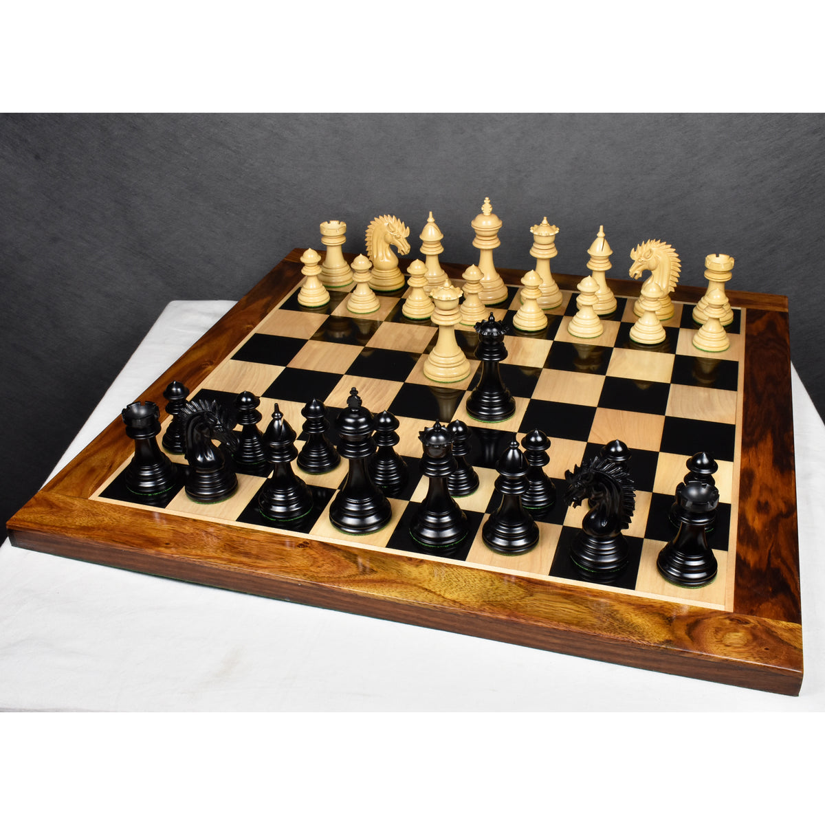 Complete 4.4 inch Dragon Luxury Staunton chess set with ebony and boxwood pieces arranged fully on a chessboard.