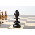 Close-up of a carved black ebony wood bishop from the Pre-Staunton Calvert chess set on a chessboard.