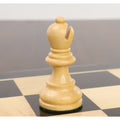 Close-up of a single natural boxwood rook from the Reykjavik Series Staunton chess set on a board.