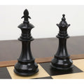 Black king and queen pieces from the 3.7" British Staunton ebonised boxwood chess set on a board.