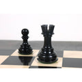 Hand-carved black Rook and pawn chess pieces.