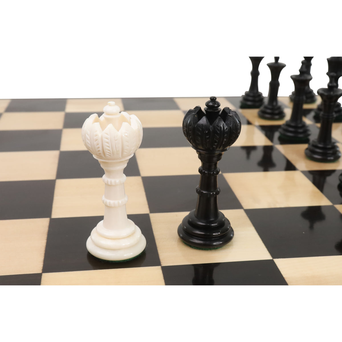Side view of black and white Turkish Tower queen pieces on a chessboard