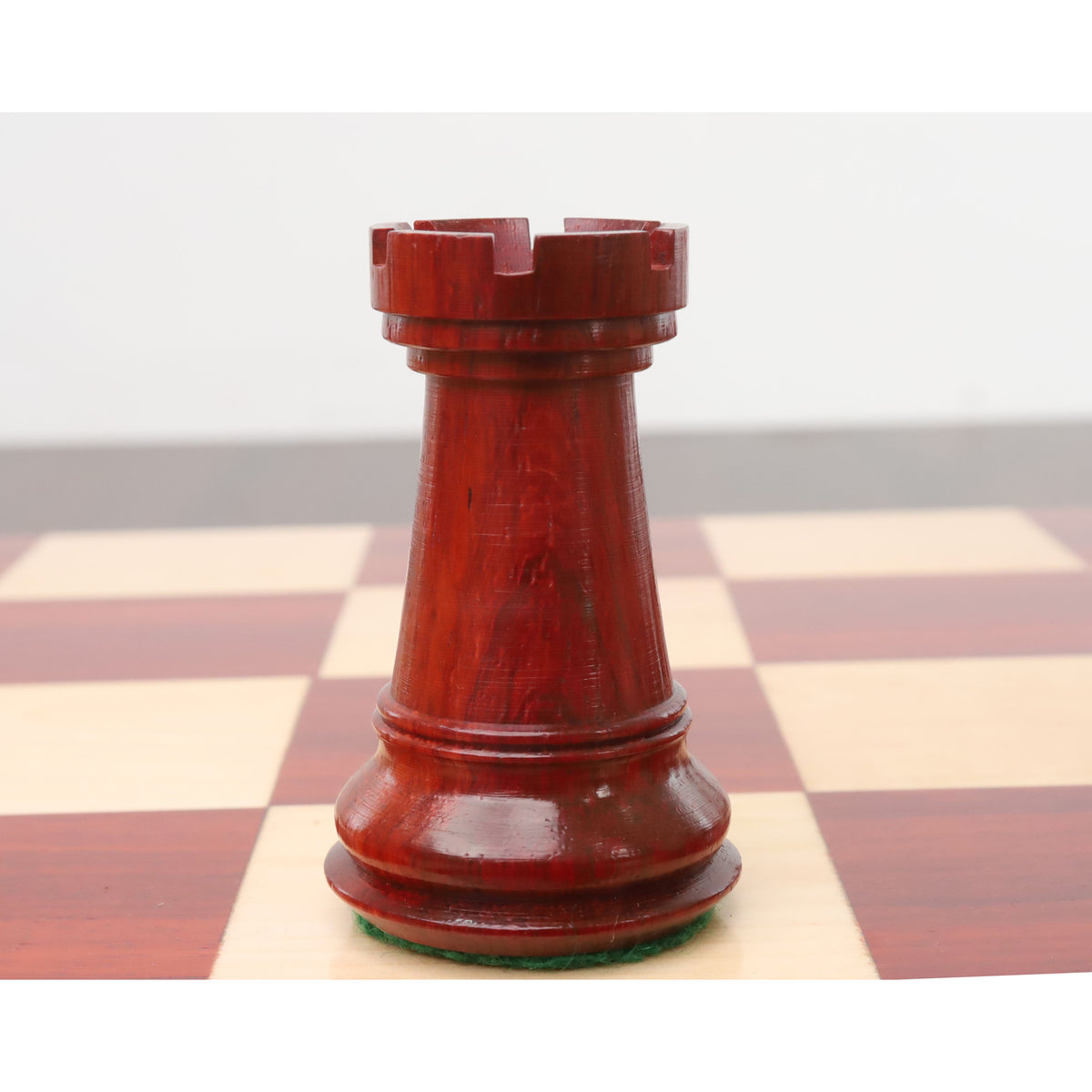 A single triple-weighted bud rosewood rook from the sleek Staunton luxury chess pieces collection.