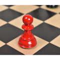 Single red Staunton pawn piece on a wooden chessboard square.