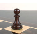 Close-up view of a dark rosewood pawn from the sleek Staunton luxury chess pieces resting on a glossy board.