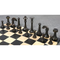 Antique brass luxury chess pieces arranged on a wooden board showing dark metal texture.