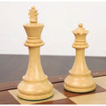 Finely crafted boxwood King and Queen from the classic Staunton chess set resting on a board.