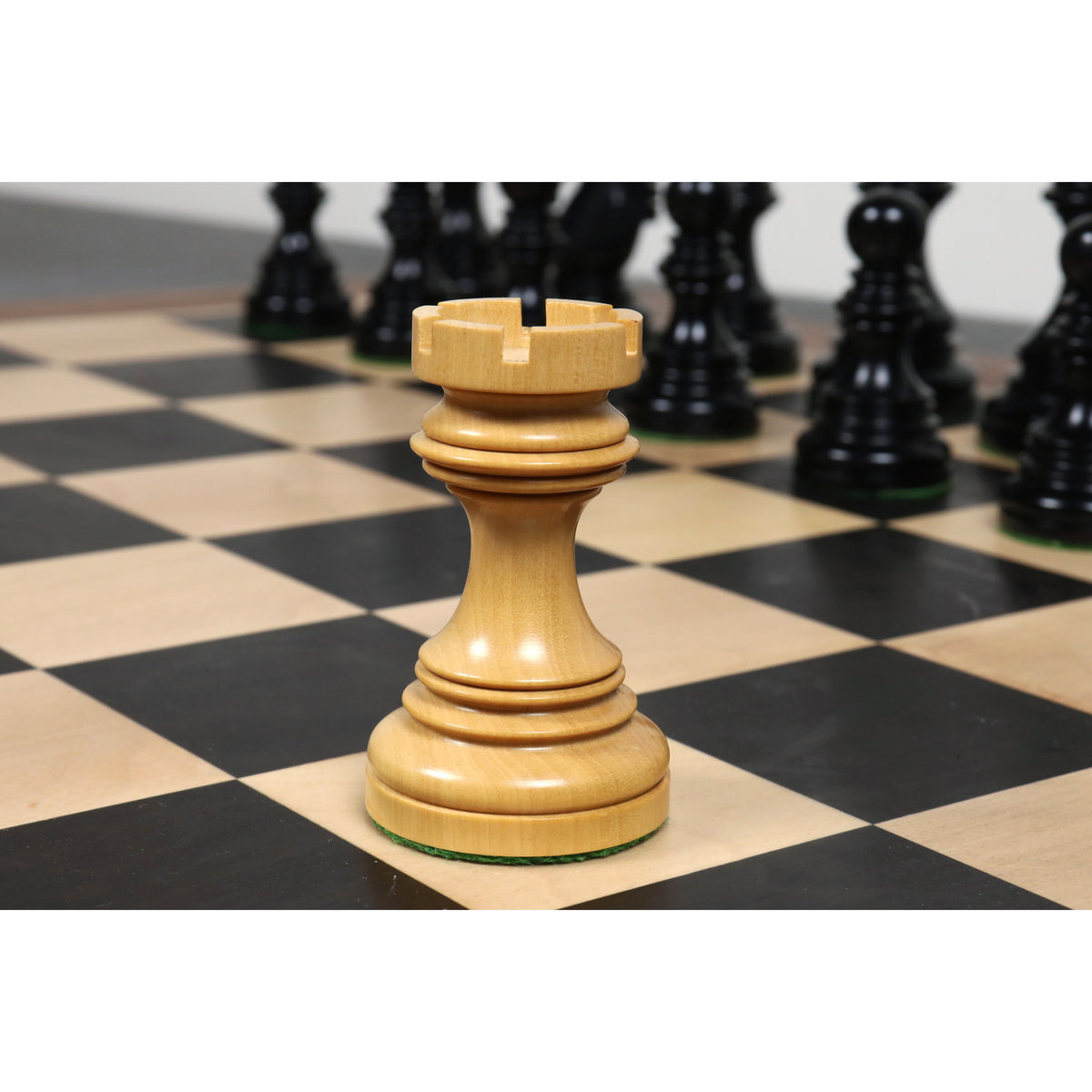 Single light boxwood rook piece from the Stallion Staunton chess set.