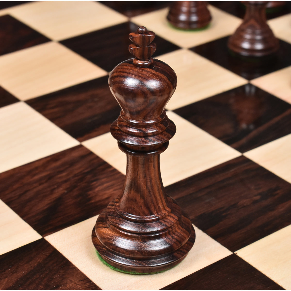 Close-up of two light boxwood Imperial Staunton knights standing side-by-side on a chessboard.