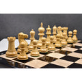 A set of light boxwood executive staunton pieces placed on a board.