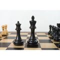 Black Pro Staunton King and Queen pieces standing on the board.