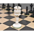 Close-up of the white camel bone Rook piece on a wooden chessboard.