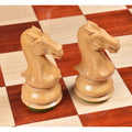 Close-up of two finely crafted Boxwood knights on a chessboard.