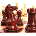 Luxury bud rosewood knight and rook pieces highlighting the glossy finish and weighted base of the Staunton set.