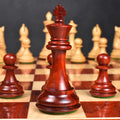 Close-up of the 3.9 inch Alban Staunton bud rosewood king positioned on the chessboard.