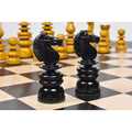 Two handcrafted ebony wood knights from the St. George Calvert pre-Staunton chess set on a board.