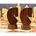Two modern minimalist golden rosewood knight chess pieces with geometric curved designs.